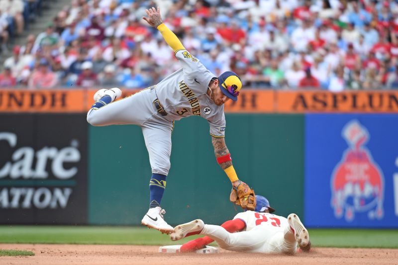 Jun 1, 2025; Philadelphia, Pennsylvania, USA; Milwaukee Brewers shortstop Joey Ortiz (3) leaps to catch throw as Philadelphia Phillies outfielder Johan Rojas (23) steals second base during the fourth inning at Citizens Bank Park. Mandatory Credit: Eric Hartline-Imagn Images