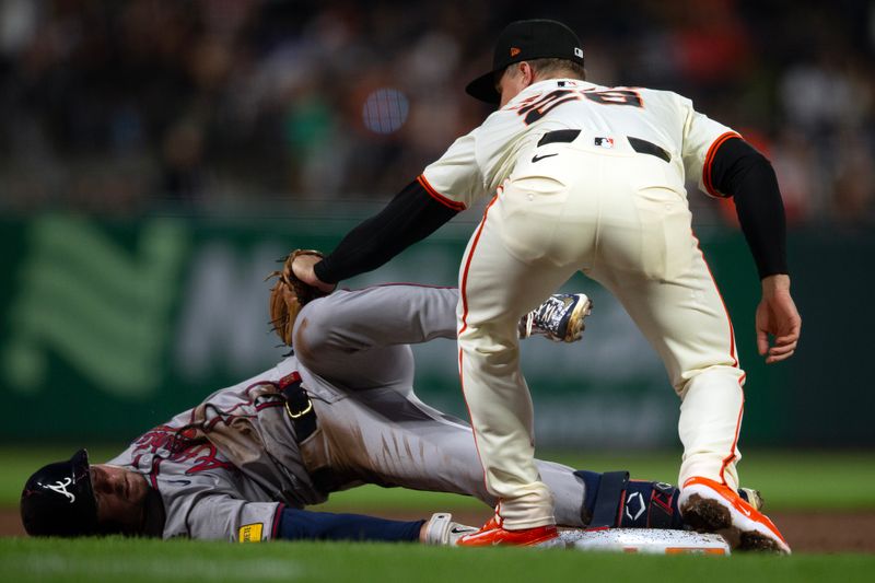Aug 14, 2024; San Francisco, California, USA; San Francisco Giants third baseman Matt Chapman (26) applies the tag too late to Atlanta Braves outfielder Jarred Kelenic (24) as he slides into third base during the sixth inning at Oracle Park. Kelenic doubled and advanced to third on a throw home. Mandatory Credit: D. Ross Cameron-USA TODAY Sports