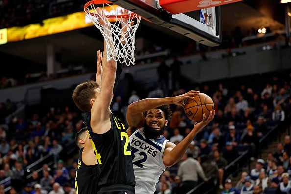 MINNEAPOLIS, MINNESOTA - NOVEMBER 30: Karl-Anthony Towns #32 of the Minnesota Timberwolves goes to the basket while Walker Kessler #24 of the Utah Jazz defends in the fourth quarter at Target Center on November 30, 2023 in Minneapolis, Minnesota. The Timberwolves defeated the Jazz 101-90. NOTE TO USER: User expressly acknowledges and agrees that, by downloading and or using this photograph, User is consenting to the terms and conditions of the Getty Images License Agreement. (Photo by David Berding/Getty Images)