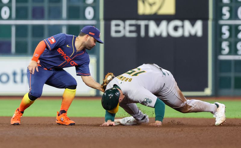 May 13, 2024; Houston, Texas, USA; Oakland Athletics left fielder Seth Brown (15) is tagged out by Houston Astros second base Jose Altuve (27) while trying to steal second base in the sixth inning at Minute Maid Park. Mandatory Credit: Thomas Shea-USA TODAY Sports