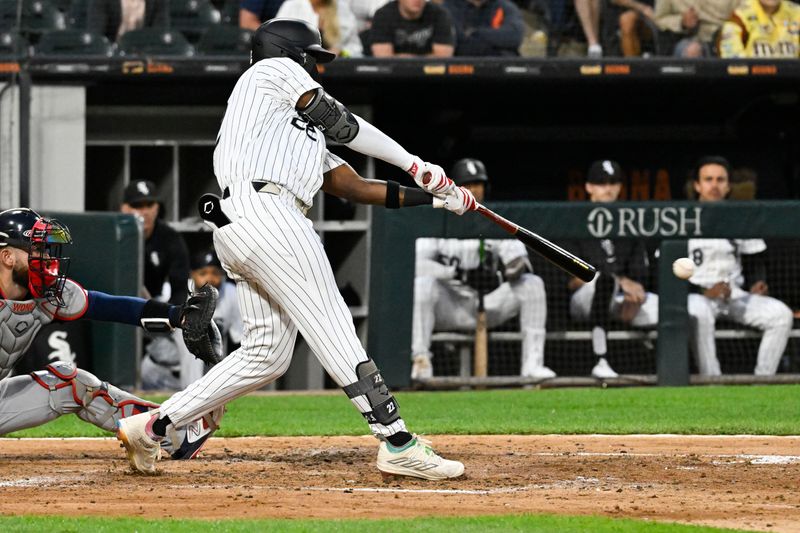 Jun 7, 2024; Chicago, Illinois, USA;  Chicago White Sox outfielder Oscar Colás (22) hits a two RBI single against the Boston Red Sox during the fourth inning at Guaranteed Rate Field. Mandatory Credit: Matt Marton-USA TODAY Sports