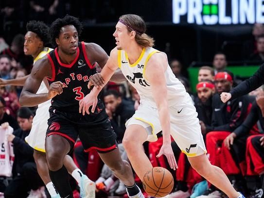 TORONTO, ON - DECEMBER 23: Kelly Olynyk #41 of the Utah Jazz dribbles against OG Anunoby #3 of the Toronto Raptors during the first half of their basketball game at the Scotiabank Arena on December 23, 2023 in Toronto, Ontario, Canada. NOTE TO USER: User expressly acknowledges and agrees that, by downloading and/or using this Photograph, user is consenting to the terms and conditions of the Getty Images License Agreement. (Photo by Mark Blinch/Getty Images)