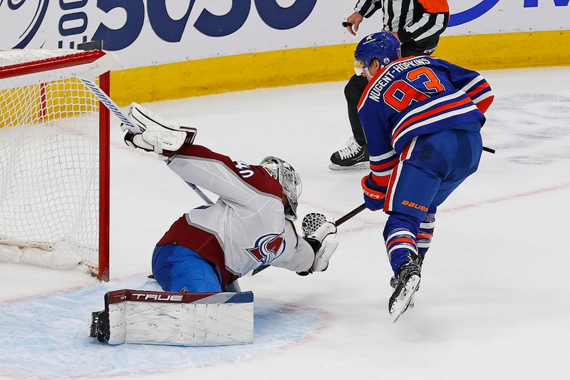 Mar 16, 2024; Edmonton, Alberta, CAN; Colorado Avalanche goaltender Alexander Georgiev (40) makes a save on Edmonton Oilers forward Ryan Nugent-Hopkins (93) during overtime at Rogers Place. Mandatory Credit: Perry Nelson-USA TODAY Sports