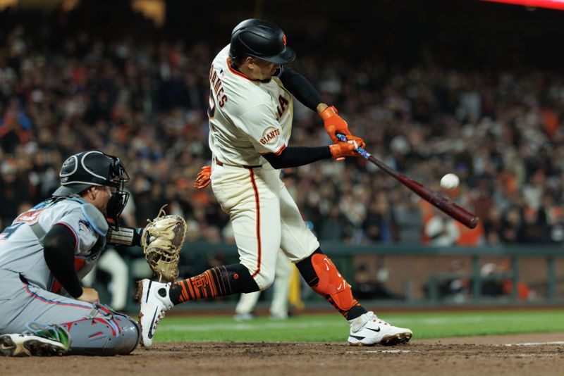 Jun 25, 2025; San Francisco, California, USA; San Francisco Giants shortstop Willy Adames (2) hits an RBI sac fly during the ninth inning against the Miami Marlins at Oracle Park. Mandatory Credit: Sergio Estrada-Imagn Images