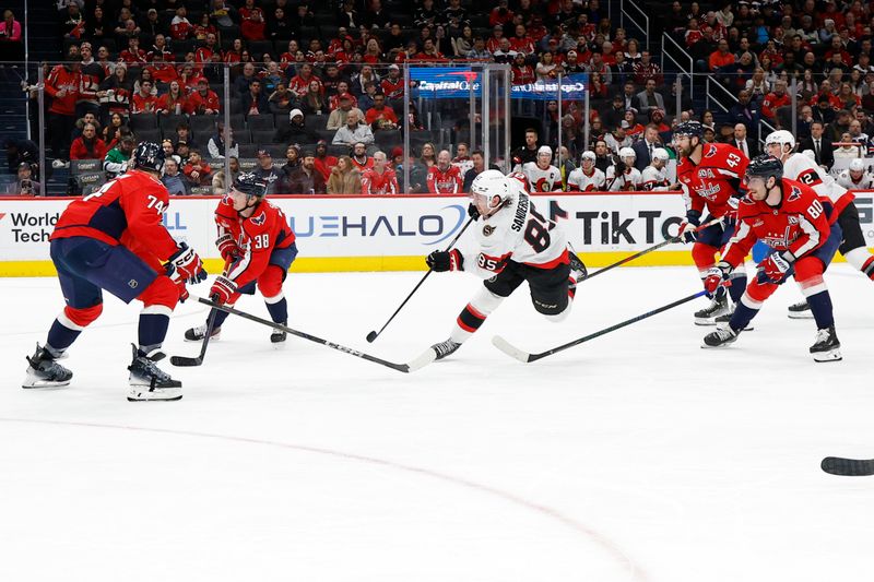 Mar 3, 2025; Washington, District of Columbia, USA; Ottawa Senators defenseman Jake Sanderson (85) shoots the puck as Washington Capitals defenseman John Carlson (74) defends in the second period at Capital One Arena. Mandatory Credit: Geoff Burke-Imagn Images