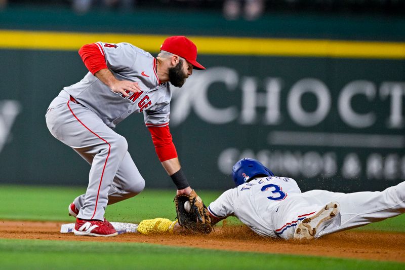 Sep 5, 2024; Arlington, Texas, USA; Texas Rangers center fielder Leody Taveras (3) slides under the tag of Los Angeles Angels second baseman Michael Stefanic (38) but is called out during the second inning at Globe Life Field. Mandatory Credit: Jerome Miron-Imagn Images