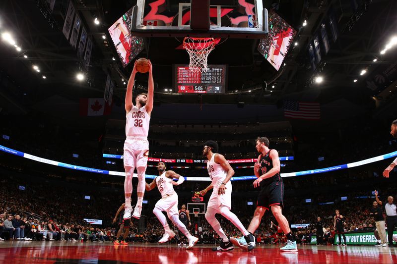 TORONTO, CANADA - FEBRUARY 10: Dean Wade #32 of the Cleveland Cavaliers grabs a rebound during the game against the Toronto Raptors on February 10, 2024 at the Scotiabank Arena in Toronto, Ontario, Canada.  NOTE TO USER: User expressly acknowledges and agrees that, by downloading and or using this Photograph, user is consenting to the terms and conditions of the Getty Images License Agreement.  Mandatory Copyright Notice: Copyright 2024 NBAE (Photo by Vaughn Ridley/NBAE via Getty Images)