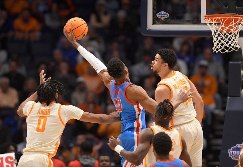 Mar 9, 2023; Nashville, TN, USA;  Mississippi Rebels forward Theo Akwuba (10) grabs the rebound from Tennessee Volunteers forward Jonas Aidoo (0) and forward Olivier Nkamhoua (13) during the first half at Bridgestone Arena. Mandatory Credit: Steve Roberts-USA TODAY Sports