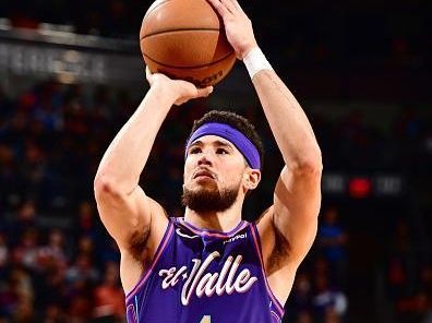 PHOENIX, AZ - DECEMBER 17: Devin Booker #1 of the Phoenix Suns shoots a free throw during the game against the Washington Wizards on December 17, 2023 at Footprint Center in Phoenix, Arizona. NOTE TO USER: User expressly acknowledges and agrees that, by downloading and or using this photograph, user is consenting to the terms and conditions of the Getty Images License Agreement. Mandatory Copyright Notice: Copyright 2023 NBAE (Photo by Barry Gossage/NBAE via Getty Images)