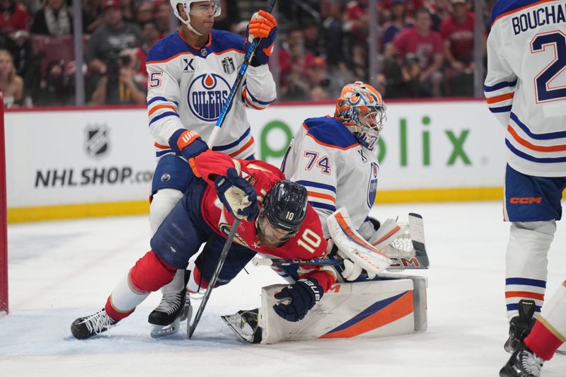 Jun 9, 2025; Sunrise, Florida, USA; Edmonton Oilers defenseman Darnell Nurse (25) and goaltender Stuart Skinner (74) defend against Florida Panthers forward A.J. Greer (10) during the second period in game three of the 2025 Stanley Cup Final at Amerant Bank Arena. Mandatory Credit: Jim Rassol-Imagn Images