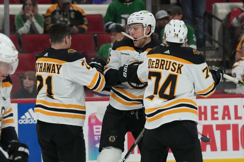 Mar 26, 2023; Raleigh, North Carolina, USA;  Boston Bruins right wing Garnet Hathaway (21) defenseman Brandon Carlo (25) and left wing Jake DeBrusk (74) mess around during the warmups against the Carolina Hurricanes at PNC Arena. Mandatory Credit: James Guillory-USA TODAY Sports