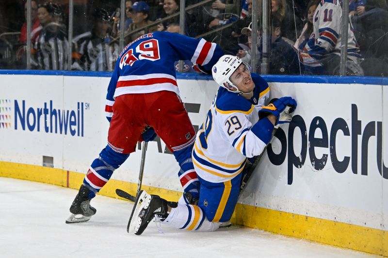 Nov 7, 2024; New York, New York, USA;  New York Rangers center Sam Carrick (39) checks Buffalo Sabres left wing Beck Malenstyn (29) into the boards during the third period at Madison Square Garden. Mandatory Credit: Dennis Schneidler-Imagn Images