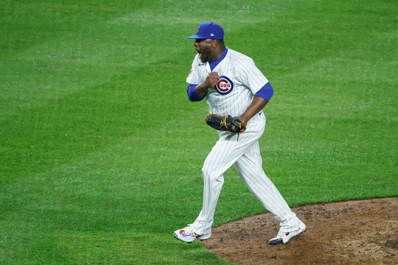 Jun 2, 2024; Chicago, Illinois, USA; Chicago Cubs relief pitcher Héctor Neris (51) reacts after delivering a final out against the Cincinnati Reds during the ninth inning at Wrigley Field. Mandatory Credit: Kamil Krzaczynski-USA TODAY Sports