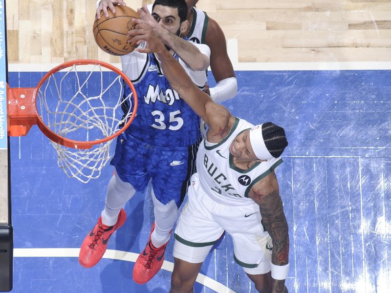 ORLANDO, FL - APRIL 14: Goga Bitadze #35 of the Orlando Magic and MarJon Beauchamp #3 of the Milwaukee Bucks battle for a rebound on April 14, 2024 at Kia Center in Orlando, Florida. NOTE TO USER: User expressly acknowledges and agrees that, by downloading and or using this photograph, User is consenting to the terms and conditions of the Getty Images License Agreement. Mandatory Copyright Notice: Copyright 2024 NBAE (Photo by Fernando Medina/NBAE via Getty Images)