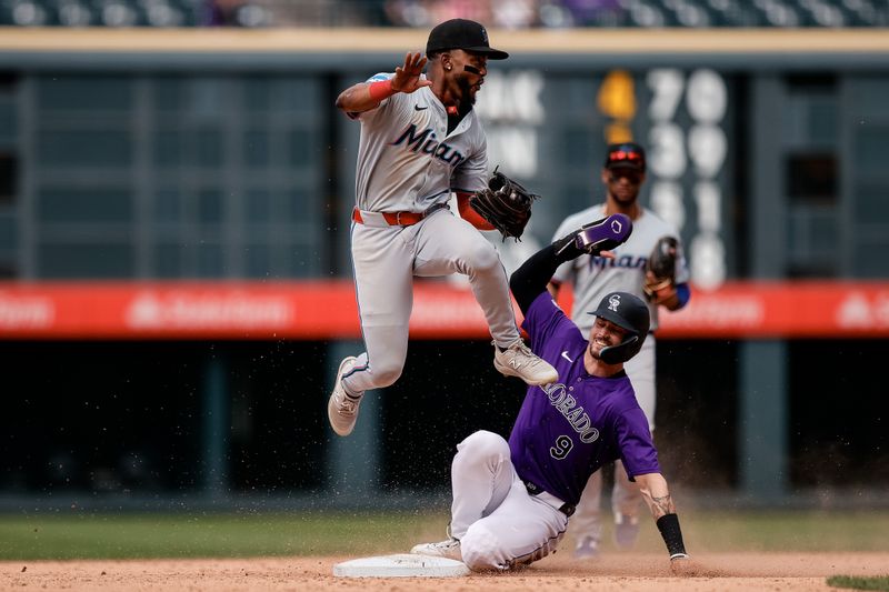 Aug 29, 2024; Denver, Colorado, USA; Colorado Rockies center fielder Brenton Doyle (9) slides out into second base against Miami Marlins shortstop Vidal Brujan (17) in the ninth inning at Coors Field. Mandatory Credit: Isaiah J. Downing-USA TODAY Sports