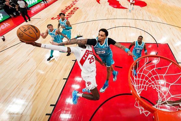 TORONTO, ON - DECEMBER 18: Chris Boucher #25 of the Toronto Raptors is fouled by P.J. Washington #25 of the Charlotte Hornets while driving to the basket during second half NBA action at Scotiabank Arena on December 18, 2023 in Toronto, Ontario, Canada. NOTE TO USER: User expressly acknowledges and agrees that, by downloading and/or using this Photograph, user is consenting to the terms and conditions of the Getty Images License Agreement. (Photo by Andrew Lahodynskyj/Getty Images)