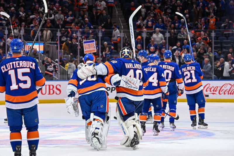 Apr 11, 2024; Elmont, New York, USA; New York Islanders goaltender Semyon Varlamov (40) and New York Islanders goaltender Ilya Sorokin (30) celebrate the 3-2 victory over the Montreal Canadiens after the game at UBS Arena. Mandatory Credit: Dennis Schneidler-USA TODAY Sports