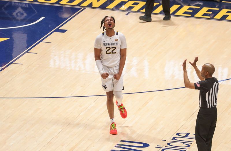 Feb 20, 2024; Morgantown, West Virginia, USA; West Virginia Mountaineers forward Josiah Harris (22) celebrates during the second half against the UCF Knights at WVU Coliseum. Mandatory Credit: Ben Queen-USA TODAY Sports