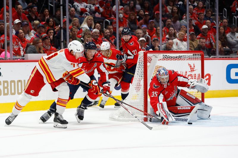 Oct 16, 2023; Washington, District of Columbia, USA; Washington Capitals goaltender Darcy Kuemper (35) makes a save on Calgary Flames center Walker Duehr (71) as Capitals defenseman John Carlson (74) defends in the second period at Capital One Arena. Mandatory Credit: Geoff Burke-USA TODAY Sports