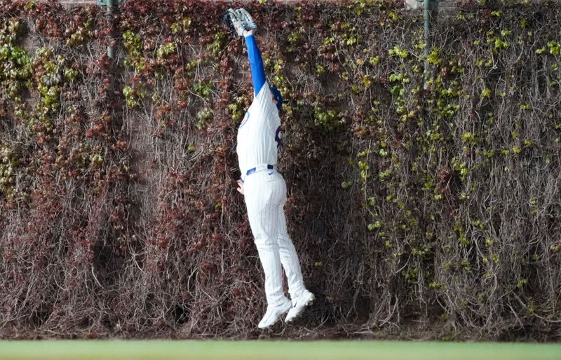 Apr 27, 2025; Chicago, Illinois, USA; Chicago Cubs outfielder Ian Happ (8) makes a catch on Philadelphia Phillies outfielder Nick Castellanos (not pictured) during the ninth inning at Wrigley Field. Mandatory Credit: David Banks-Imagn Images