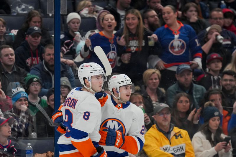 Apr 4, 2024; Columbus, Ohio, USA;  New York Islanders defenseman Noah Dobson (8) celebrates scoring a goal with defenseman Alexander Romanov (28) in the game against the Columbus Blue Jackets in the third period at Nationwide Arena. Mandatory Credit: Aaron Doster-USA TODAY Sports