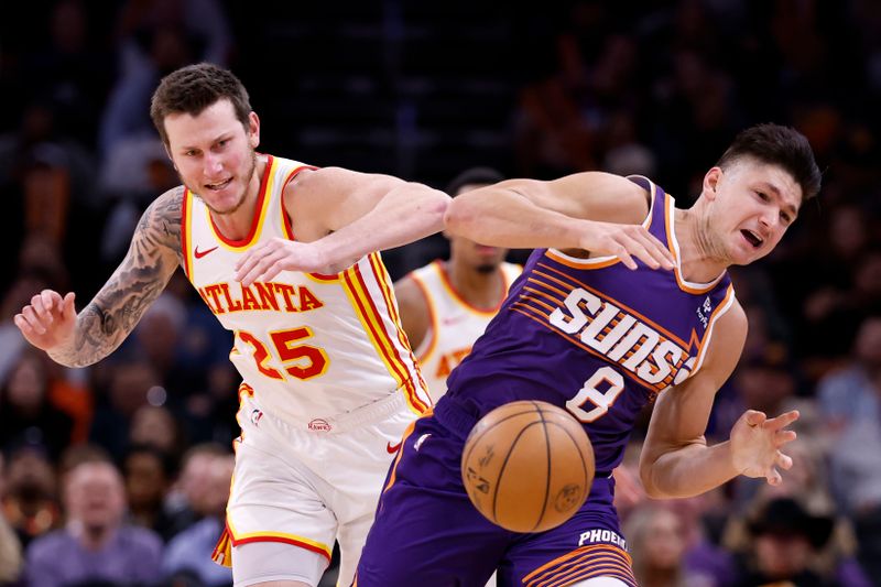 PHOENIX, ARIZONA - MARCH 21: Garrison Mathews #25 of the Atlanta Hawks and Grayson Allen #8 of the Phoenix Suns battle for a loose ball during the second half at Footprint Center on March 21, 2024 in Phoenix, Arizona. NOTE TO USER: User expressly acknowledges and agrees that, by downloading and or using this photograph, User is consenting to the terms and conditions of the Getty Images License Agreement.  (Photo by Chris Coduto/Getty Images)