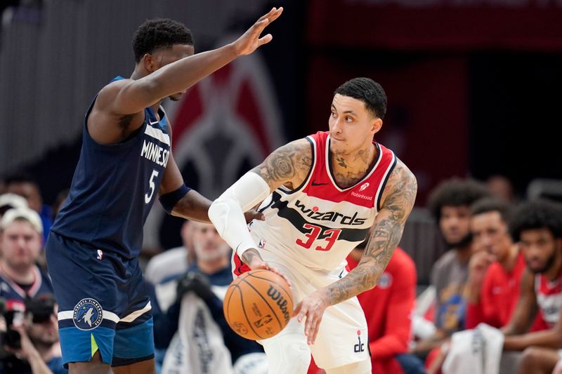 WASHINGTON, DC - JANUARY 24: Kyle Kuzma #33 of the Washington Wizards passes the ball against Anthony Edwards #5 of the Minnesota Timberwolves during the first half at Capital One Arena on January 24, 2024 in Washington, DC. NOTE TO USER: User expressly acknowledges and agrees that, by downloading and or using this photograph, User is consenting to the terms and conditions of the Getty Images License Agreement. (Photo by Jess Rapfogel/Getty Images)