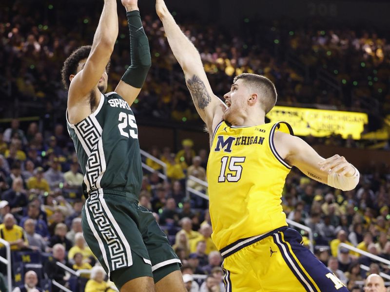 Feb 18, 2023; Ann Arbor, Michigan, USA; Michigan State Spartans forward Malik Hall (25) shoots the ball against Michigan Wolverines guard Joey Baker (15) in the second half at Crisler Center. Mandatory Credit: Rick Osentoski-USA TODAY Sports