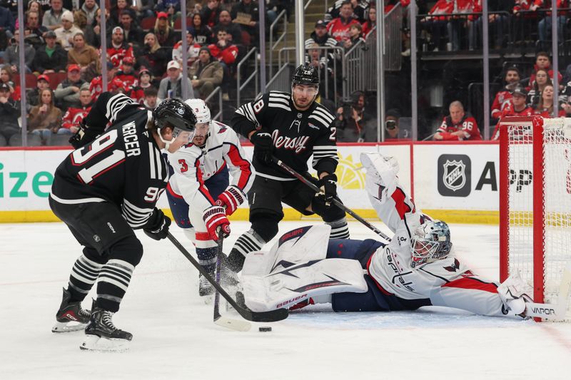 Dec 27, 2025; Newark, New Jersey, USA; Washington Capitals goaltender Logan Thompson (48) makes a save on New Jersey Devils center Dawson Mercer (91) during the second period at Prudential Center. Mandatory Credit: Ed Mulholland-Imagn Images