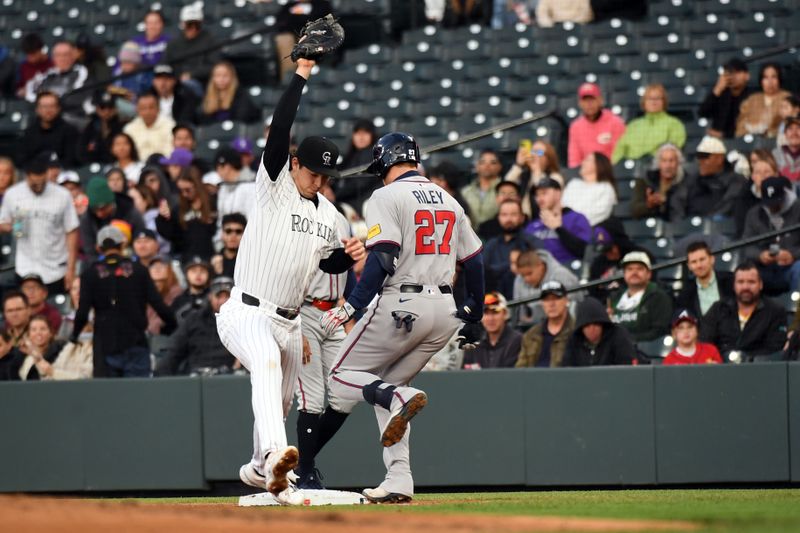 Apr 29, 2025; Denver, Colorado, USA; Colorado Rockies first base Michael Toglia (4) stretches to make the out on a play by Atlanta Braves third base Austin Riley (27) during the fourth inning at Coors Field. Mandatory Credit: Christopher Hanewinckel-Imagn Images