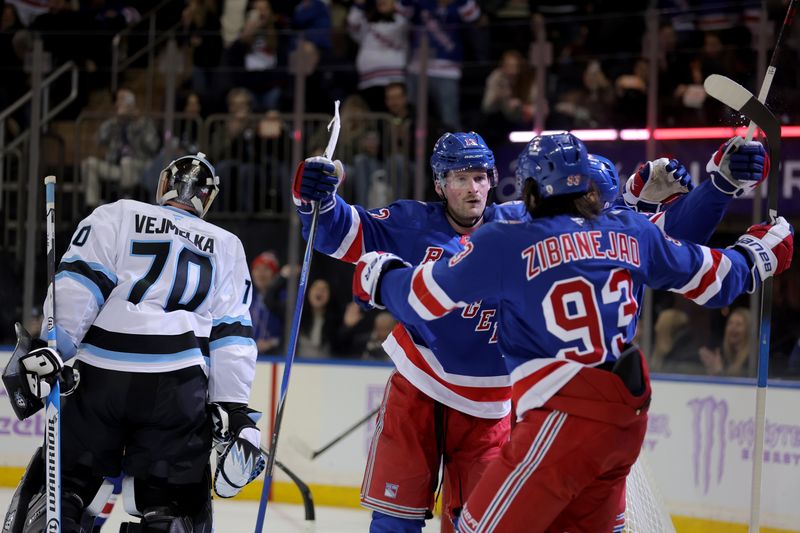 Jan 5, 2026; New York, New York, USA; New York Rangers left wing Alexis Lafreniere (13) celebrates his goal against Utah Mammoth goaltender Karel Vejmelka (70) with center Mika Zibanejad (93) during the second period at Madison Square Garden. Mandatory Credit: Brad Penner-Imagn Images