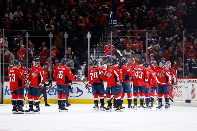 Jan 14, 2025; Washington, District of Columbia, USA; Washington Capitals players celebrate after their game against the Anaheim Ducks at Capital One Arena. Mandatory Credit: Geoff Burke-Imagn Images