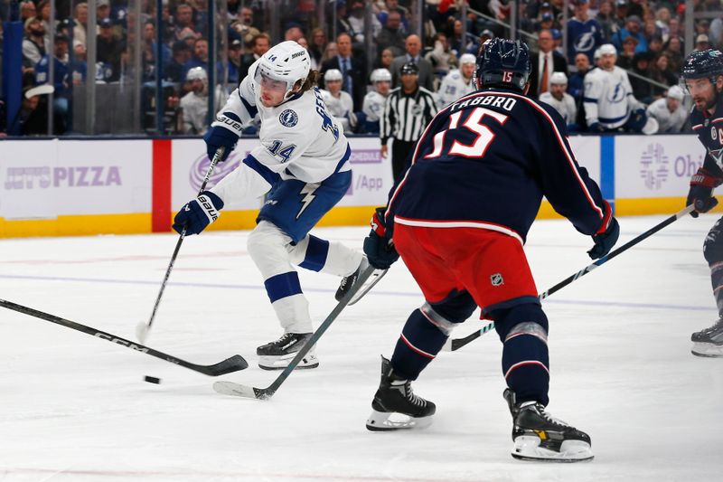 Nov 21, 2024; Columbus, Ohio, USA; Tampa Bay Lightning center Conor Geekie (14) shoots on goal as Columbus Blue Jackets defenseman Dante Fabbro (15) defends during the third period at Nationwide Arena. Mandatory Credit: Russell LaBounty-Imagn Images