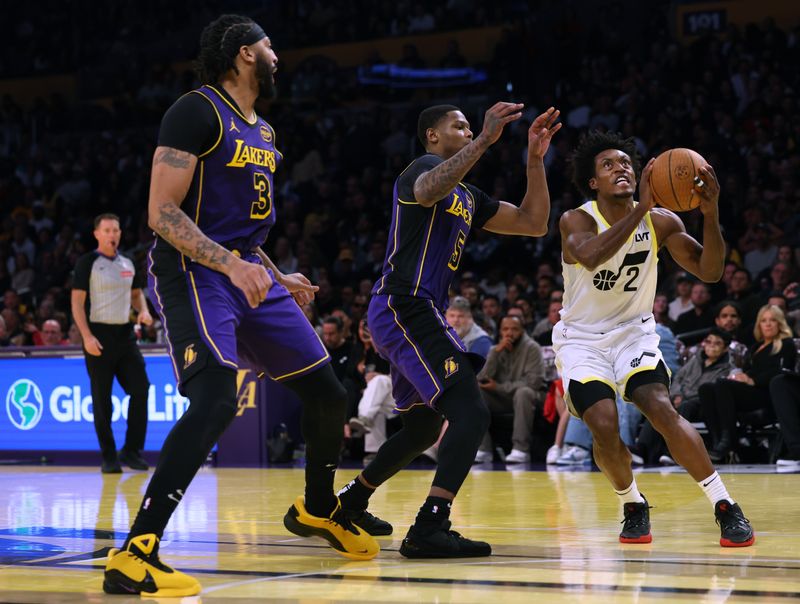 LOS ANGELES, CALIFORNIA - NOVEMBER 19: Collin Sexton #2 of the Utah Jazz attempts a layup in front of Cam Reddish #5 and Anthony Davis #3 of the Los Angeles Lakers during a 124-118 loss to the Lakers at Crypto.com Arena on November 19, 2024 in Los Angeles, California. (Photo by Harry How/Getty Images) NOTE TO USER: User expressly acknowledges and agrees that, by downloading and or using this photograph, User is consenting to the terms and conditions of the Getty Images License Agreement.  (Photo by Harry How/Getty Images)