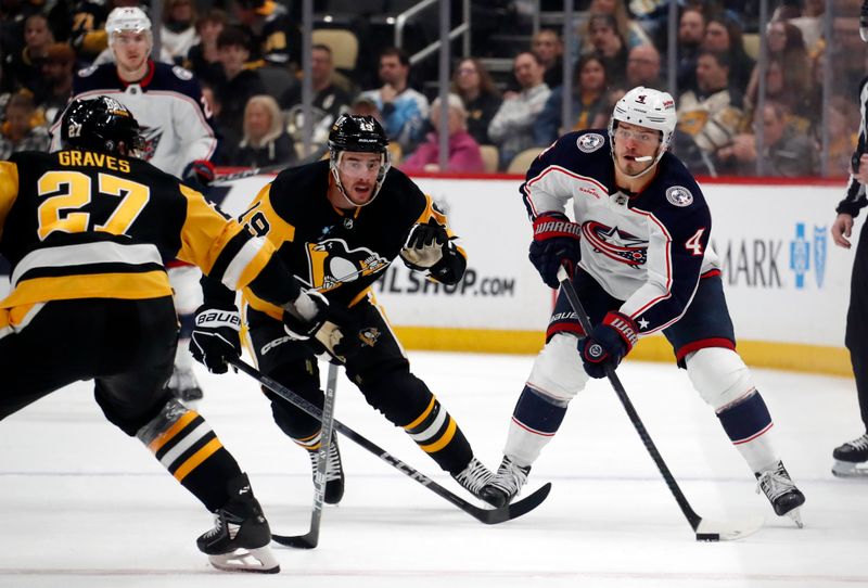 Mar 5, 2024; Pittsburgh, Pennsylvania, USA; Columbus Blue Jackets center Cole Sillinger (4) moves the puck as Pittsburgh Penguins defenseman Ryan Graves (27) and right wing Reilly Smith (19) defend during the second period at PPG Paints Arena. Mandatory Credit: Charles LeClaire-USA TODAY Sports