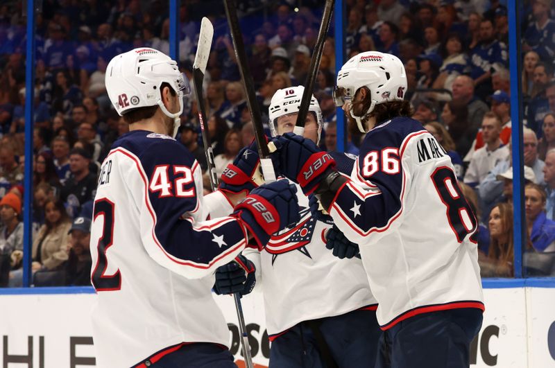 Apr 9, 2024; Tampa, Florida, USA; Columbus Blue Jackets right wing Kirill Marchenko (86) is congratulated after he scored a goal against the Tampa Bay Lightning during the second period at Amalie Arena. Mandatory Credit: Kim Klement Neitzel-USA TODAY Sports