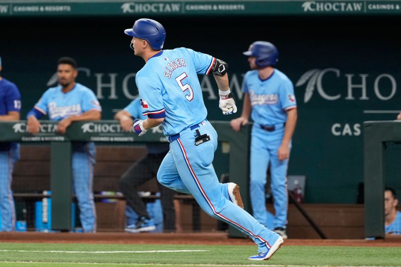 Jun 23, 2024; Arlington, Texas, USA; Texas Rangers shortstop Corey Seager (5) runs to first base on his single against the Kansas City Royals during the sixth inning at Globe Life Field. Mandatory Credit: Jim Cowsert-USA TODAY Sports