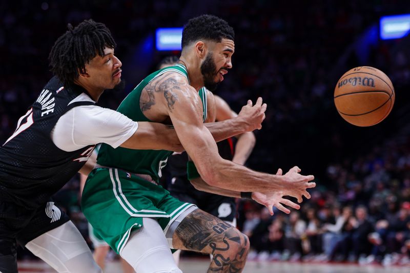 PORTLAND, OREGON - MARCH 23: Shaedon Sharpe #17 of the Portland Trail Blazers pokes the ball away from Jayson Tatum #0 of the Boston Celtics during the fourth quarter at the Moda Center on March 23, 2025 in Portland, Oregon. NOTE TO USER: User expressly acknowledges and agrees that, by downloading and or using this photograph, User is consenting to the terms and conditions of the Getty Images License Agreement. (Photo by Rio Giancarlo/Getty Images)