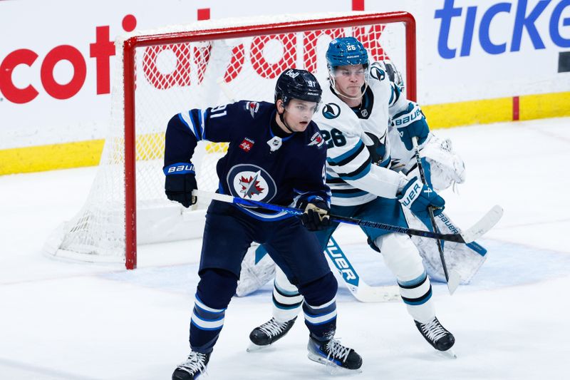Feb 24, 2025; Winnipeg, Manitoba, CAN;  Winnipeg Jets forward Cole Perfetti (91) jostles for position with San Jose Sharks defenseman Jack Thompson (26) during the third period at Canada Life Centre. Mandatory Credit: Terrence Lee-Imagn Images