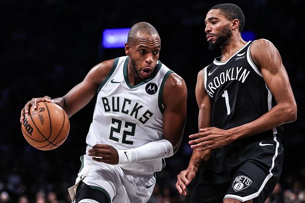 NEW YORK, NEW YORK - DECEMBER 27: Khris Middleton #22 of the Milwaukee Bucks is defended by Mikal Bridges #1 of the Brooklyn Nets during the first quarter of the game at Barclays Center on December 27, 2023 in New York City. NOTE TO USER: User expressly acknowledges and agrees that, by downloading and or using this photograph, User is consenting to the terms and conditions of the Getty Images License Agreement. (Photo by Dustin Satloff/Getty Images)