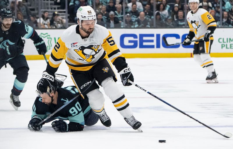 Feb 29, 2024; Seattle, Washington, USA; Pittsburgh Penguins forward Emil Bemstrom (52) skates against Seattle Kraken forward Tomas Tatar (90) during the first period at Climate Pledge Arena. Mandatory Credit: Stephen Brashear-USA TODAY Sports