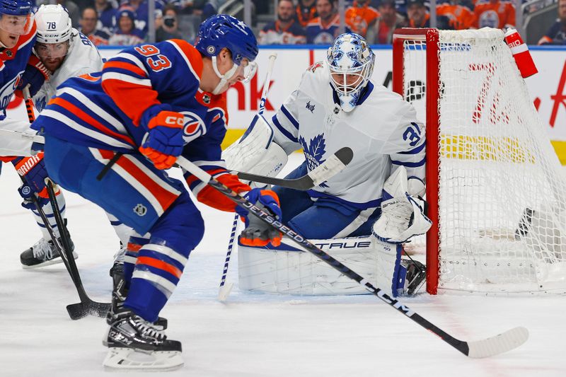 Jan 16, 2024; Edmonton, Alberta, CAN; Edmonton Oilers forward Ryan Nugent-Hopkins (93) takes a shot on Toronto Maple Leafs goaltender Martin Jones (31) during the first period at Rogers Place. Mandatory Credit: Perry Nelson-USA TODAY Sports