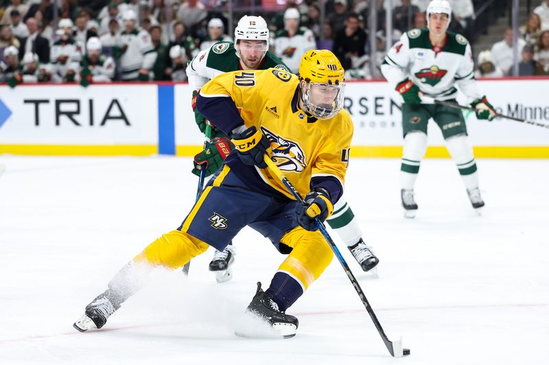 Nov 30, 2024; Saint Paul, Minnesota, USA; Nashville Predators center Fedor Svechkov (40) skates with the puck as Minnesota Wild center Yakov Trenin (13) defends during the first period at Xcel Energy Center. Mandatory Credit: Matt Krohn-Imagn Images