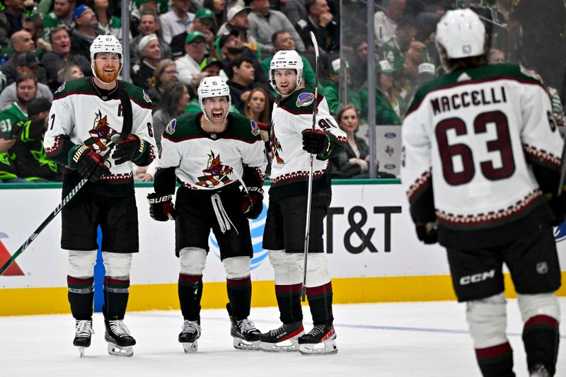 Nov 14, 2023; Dallas, Texas, USA; Arizona Coyotes left wing Lawson Crouse (67) and left wing Jason Zucker (16) and defenseman J.J. Moser (90) and left wing Matias Maccelli (63) celebrates a goal scored by Zucker against the Dallas Stars during the third period at the American Airlines Center. Mandatory Credit: Jerome Miron-USA TODAY Sports