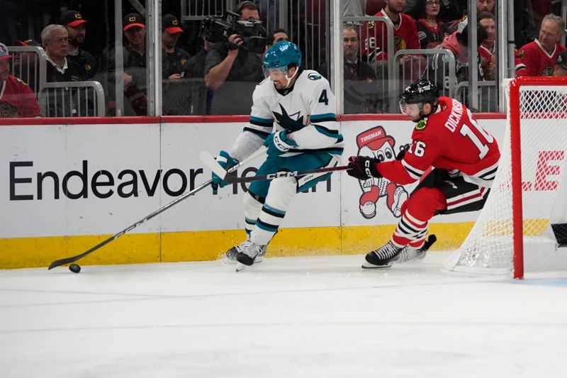 Oct 17, 2024; Chicago, Illinois, USA; Chicago Blackhawks center Jason Dickinson (16) defends San Jose Sharks defenseman Cody Ceci (4) during the third period at United Center. Mandatory Credit: David Banks-Imagn Images