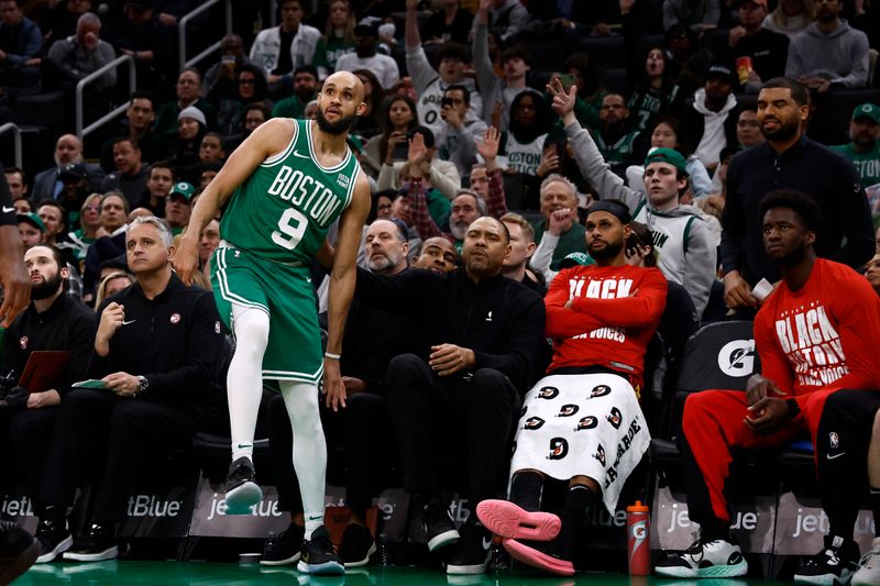 BOSTON, MA - FEBRUARY 7: Derrick White #9 of the Boston Celtics falls into the Atlanta Hawks bench as he watches his three-point attempt during the second half at TD Garden on February 7, 2024 in Boston, Massachusetts. NOTE TO USER: User expressly acknowledges and agrees that, by downloading and/or using this Photograph, user is consenting to the terms and conditions of the Getty Images License Agreement. (Photo By Winslow Townson/Getty Images)