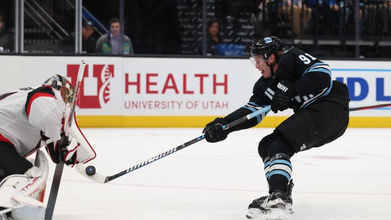 Oct 22, 2024; Salt Lake City, Utah, USA; Utah Hockey Club right wing Josh Doan (91) flips the puck toward Ottawa Senators goaltender Anton Forsberg (31) during the second period at Delta Center. Mandatory Credit: Rob Gray-Imagn Images