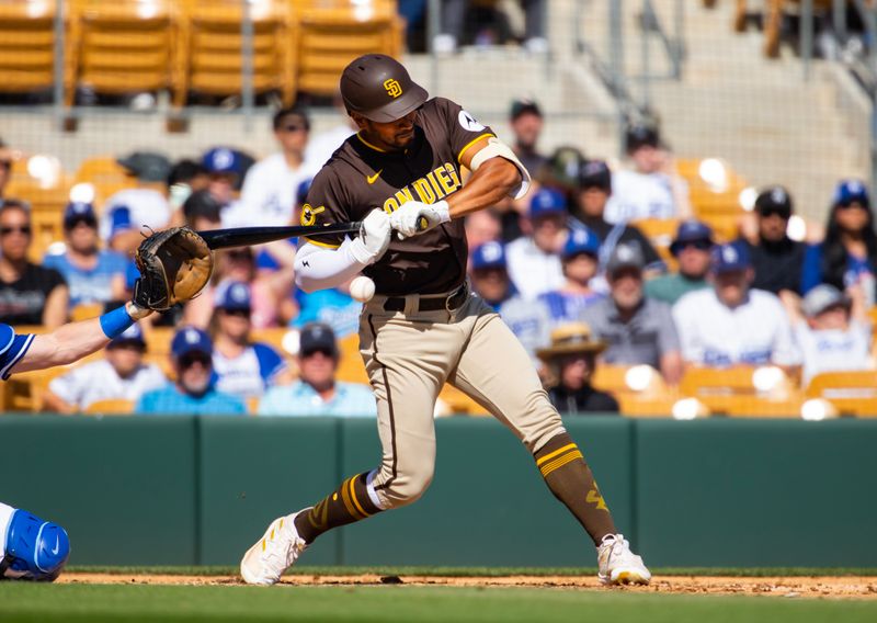 Feb 23, 2024; Phoenix, Arizona, USA; San Diego Padres outfielder Oscar Mercado is hit by a pitch against the Los Angeles Dodgers during a spring training game at Camelback Ranch-Glendale. Mandatory Credit: Mark J. Rebilas-USA TODAY Sports