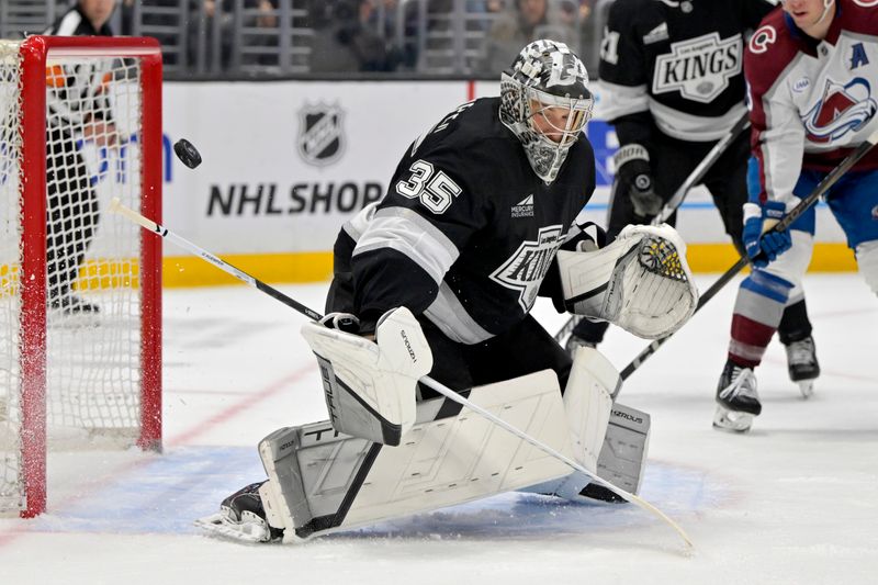Apr 12, 2025; Los Angeles, California, USA; Los Angeles Kings goaltender Darcy Kuemper (35) deflects a shot on goal during the first period against the Colorado Avalanche at Crypto.com Arena. Mandatory Credit: Jayne Kamin-Oncea-Imagn Images