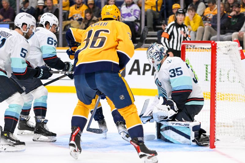 Oct 15, 2024; Nashville, Tennessee, USA;  Seattle Kraken goaltender Joey Daccord (35) blocks the shot of Nashville Predators left wing Cole Smith (36) during the first period at Bridgestone Arena. Mandatory Credit: Steve Roberts-Imagn Images